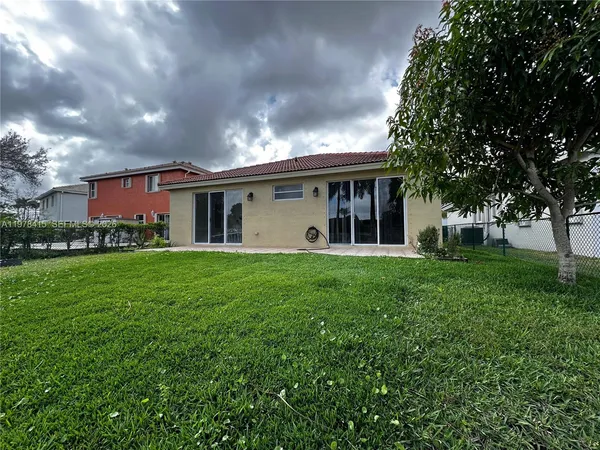 a view of an house with backyard space and garden
