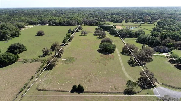 an aerial view of residential house with outdoor space