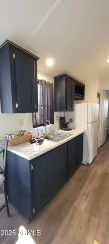 a kitchen with a sink and a refrigerator