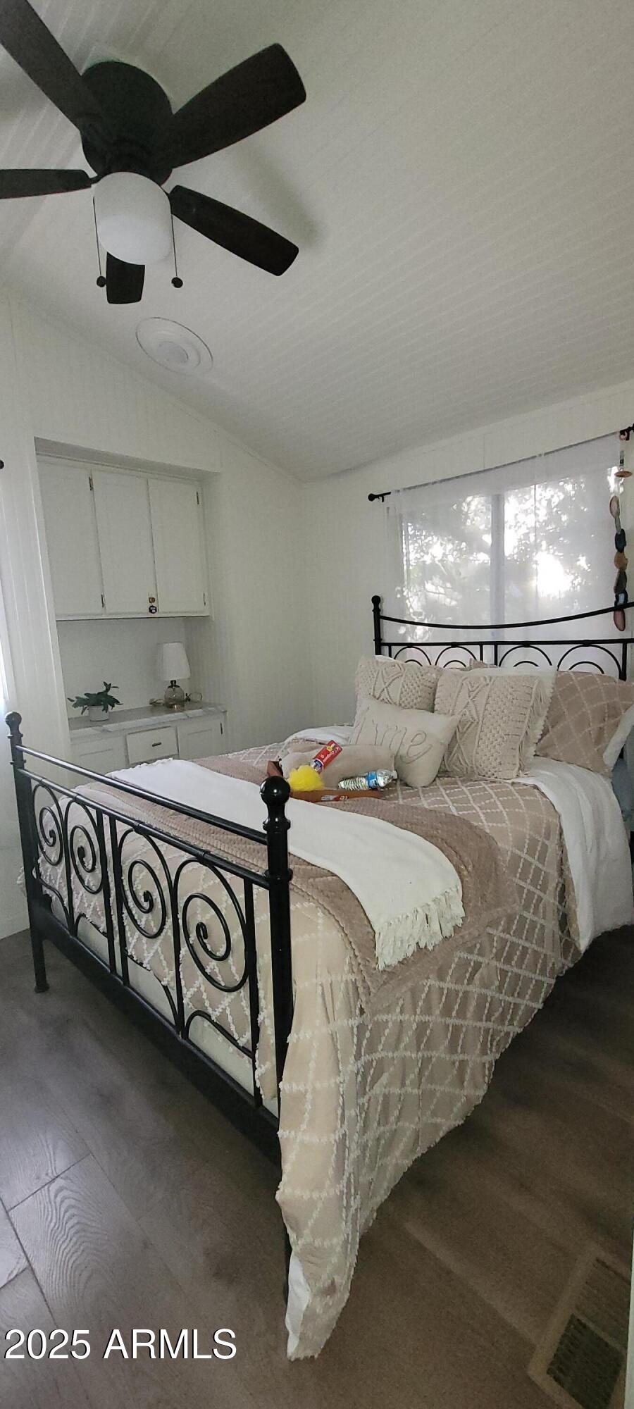 22219 West Blue Sky Drive, Unit CASITA Wittmann, AZ 85361 - Photo 6 of 15 a bedroom with a bed and ceiling fan