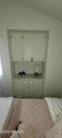a bedroom with a bed and cabinets