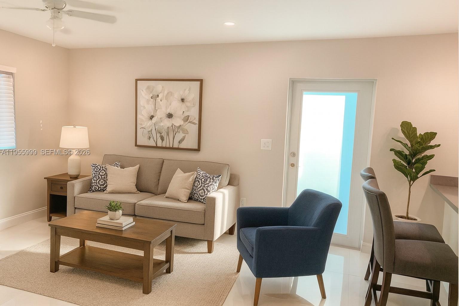 a living room with furniture and a potted plant