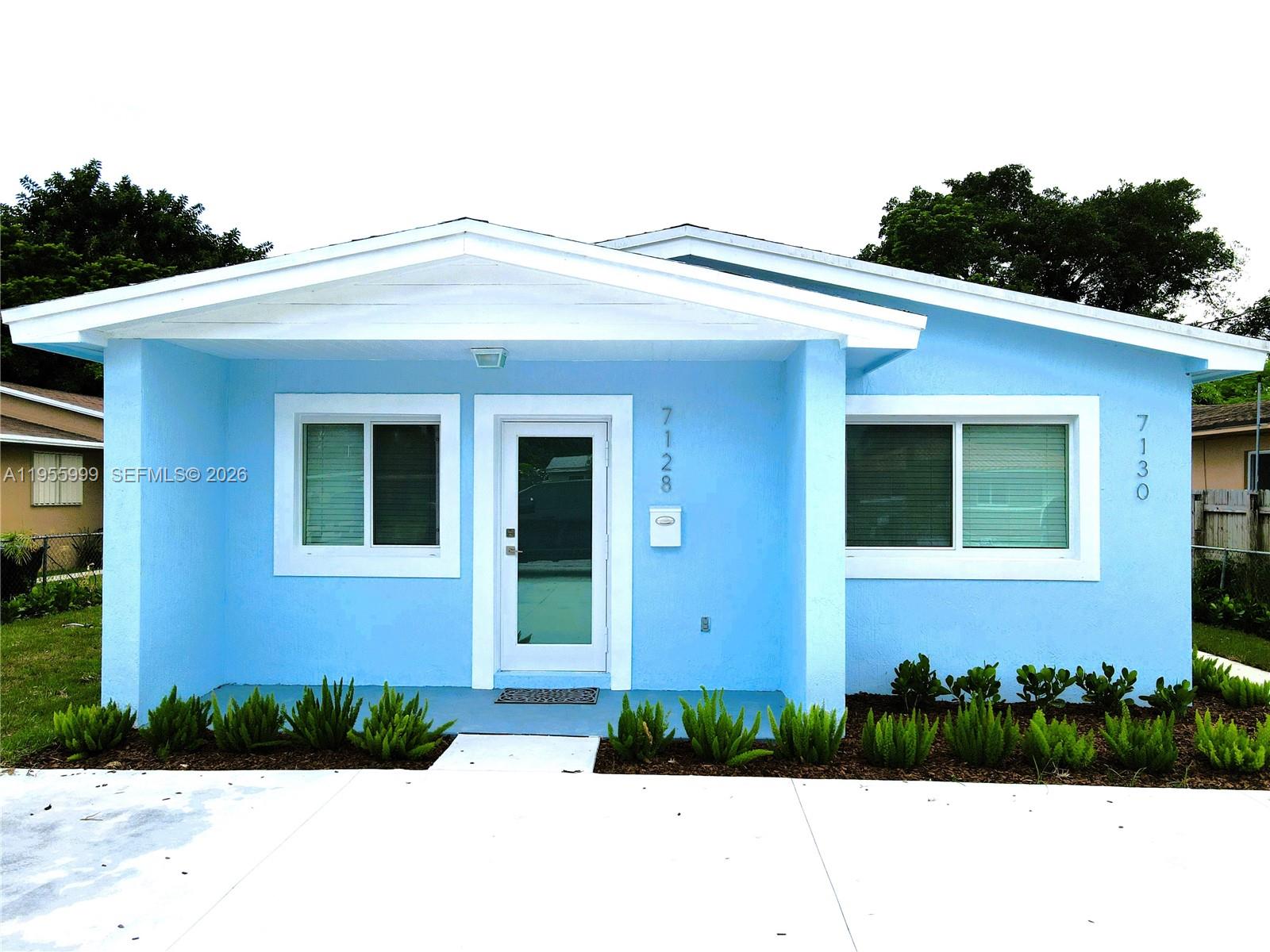 7128 Southwest 22nd Street, Unit 7128 Miami, FL 33155 - Photo 13 of 19 a front view of a house with a yard