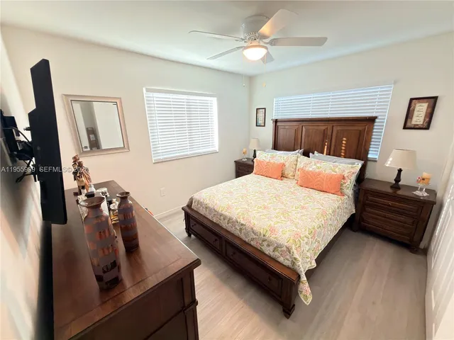 a bedroom with a bed a couch and dresser