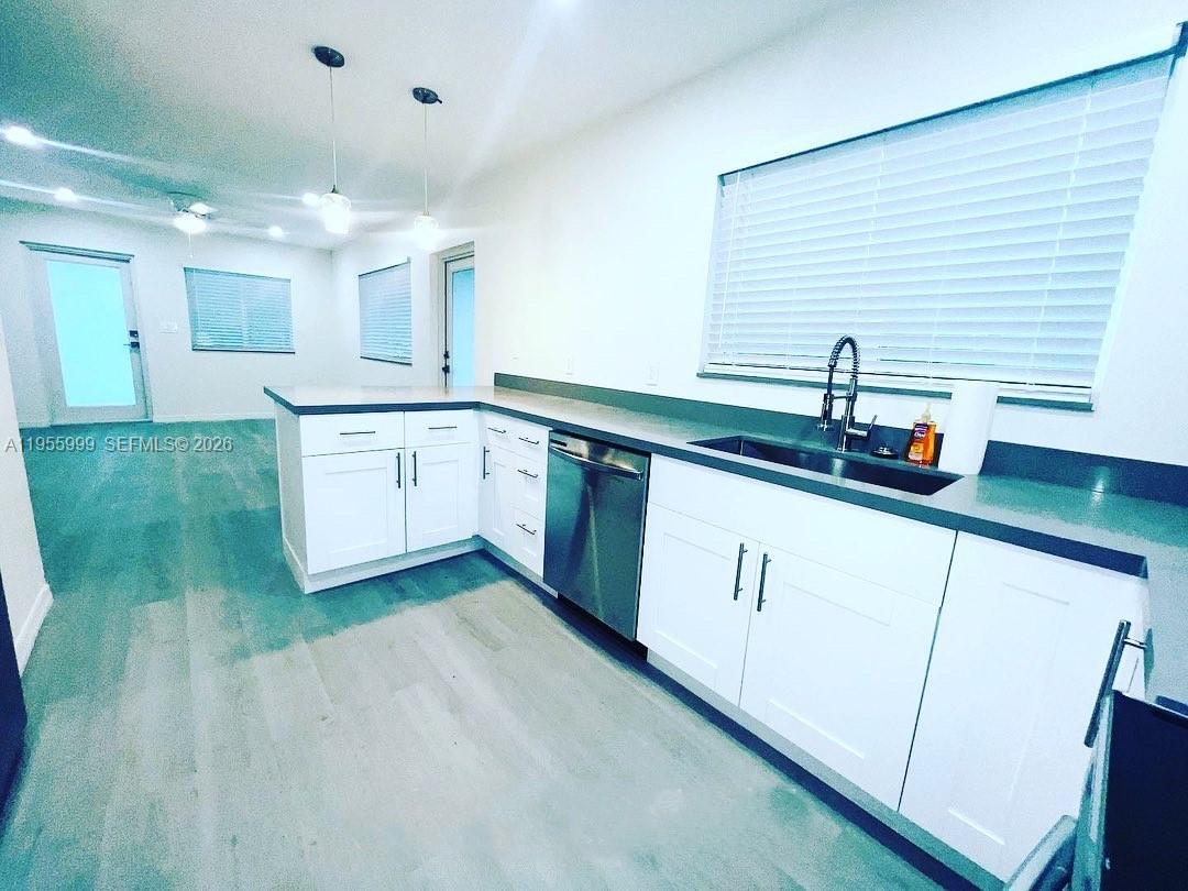 7128 Southwest 22nd Street, Unit 7128 Miami, FL 33155 - Photo 3 of 19 a kitchen with a sink and cabinets