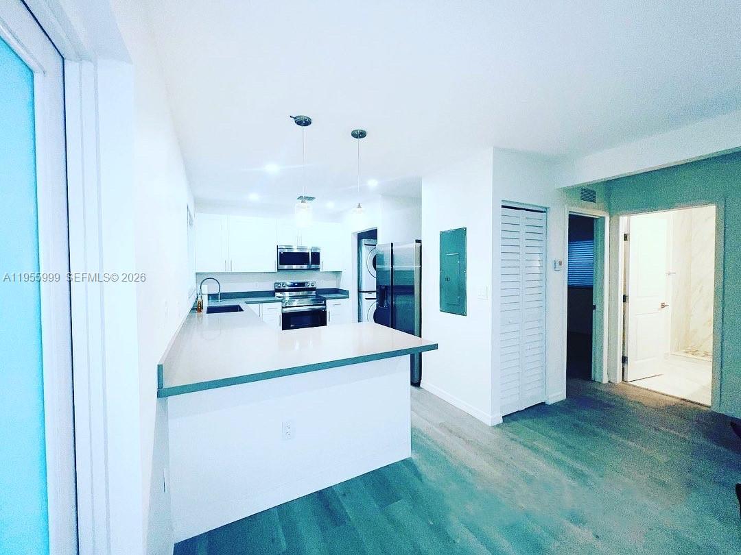 7128 Southwest 22nd Street, Unit 7128 Miami, FL 33155 - Photo 4 of 19 a view of kitchen with furniture and wooden floor