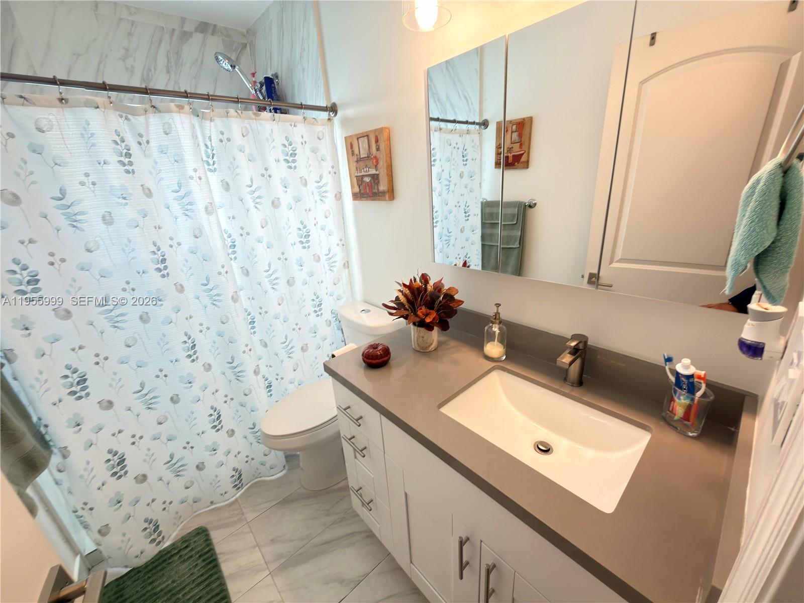 7128 Southwest 22nd Street, Unit 7128 Miami, FL 33155 - Photo 7 of 19 a bathroom with a sink toilet and shower