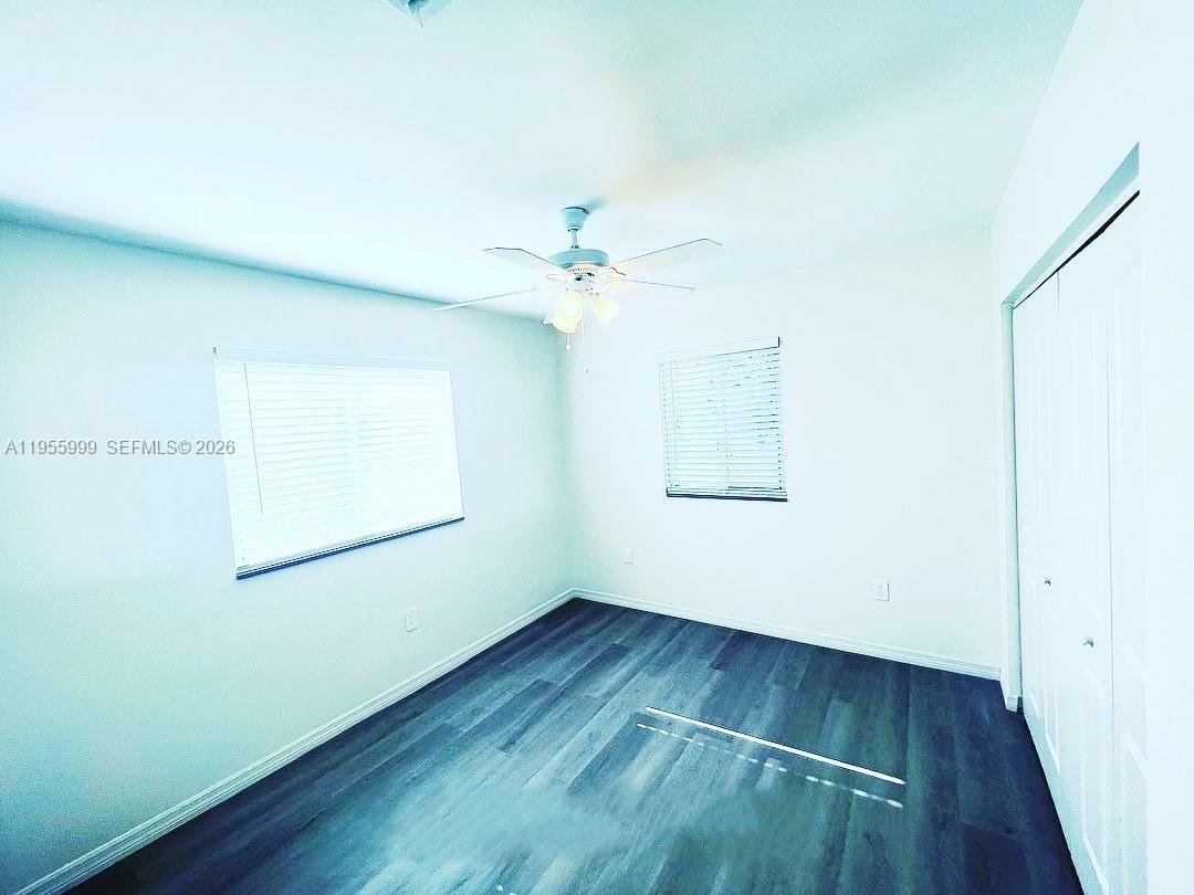 7128 Southwest 22nd Street, Unit 7128 Miami, FL 33155 - Photo 10 of 19 an empty room with wooden floor and windows