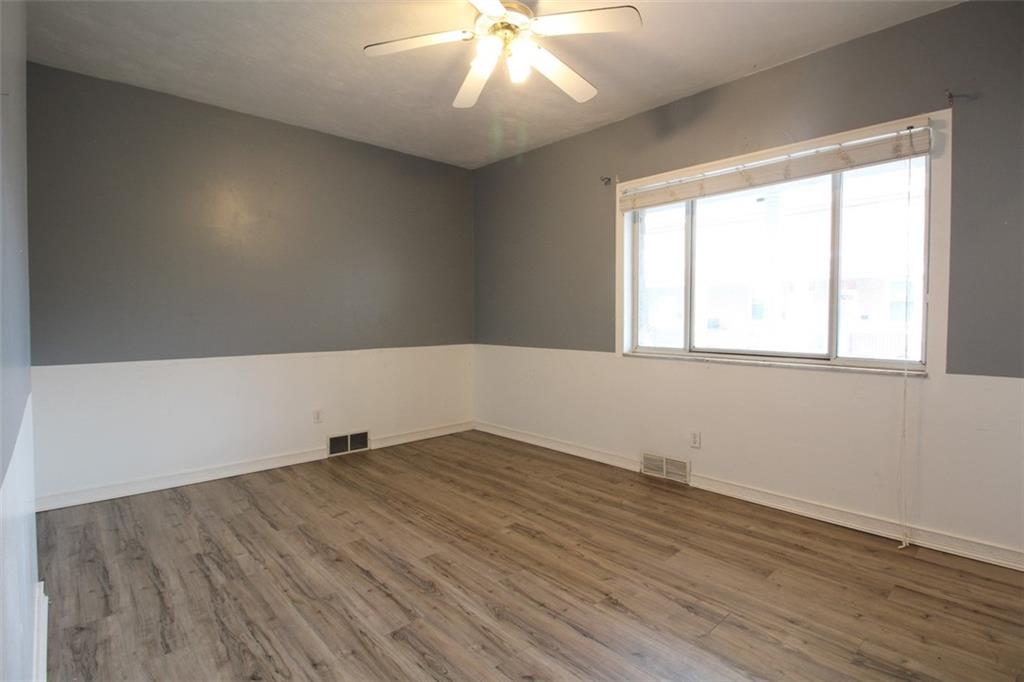 202 Jane Street McKees Rocks, PA 15136 - Photo 11 of 44 an empty room with wooden floor and windows