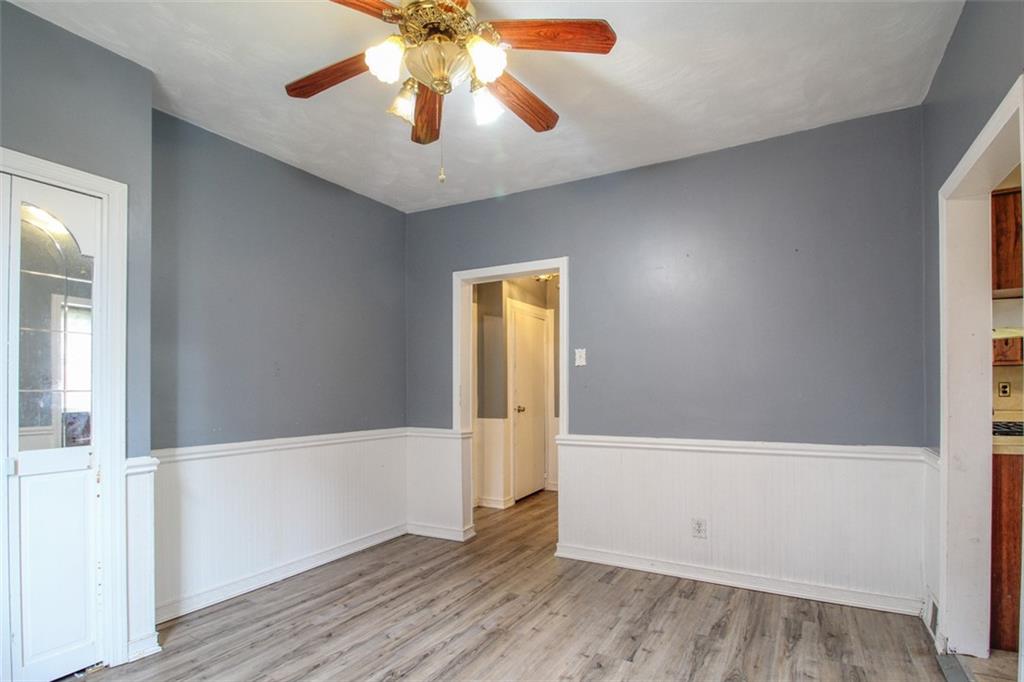 202 Jane Street McKees Rocks, PA 15136 - Photo 15 of 44 an empty room with wooden floor chandelier fan and windows