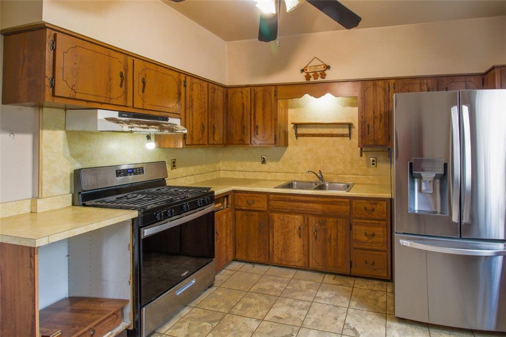 202 Jane Street McKees Rocks, PA 15136 - Photo 17 of 44 a kitchen with stainless steel appliances granite countertop a stove a refrigerator and a sink