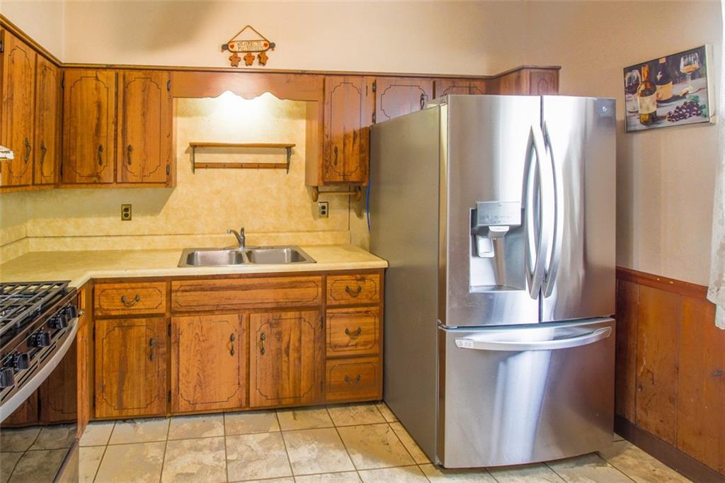 202 Jane Street McKees Rocks, PA 15136 - Photo 18 of 44 a kitchen with stainless steel appliances granite countertop a refrigerator and a sink