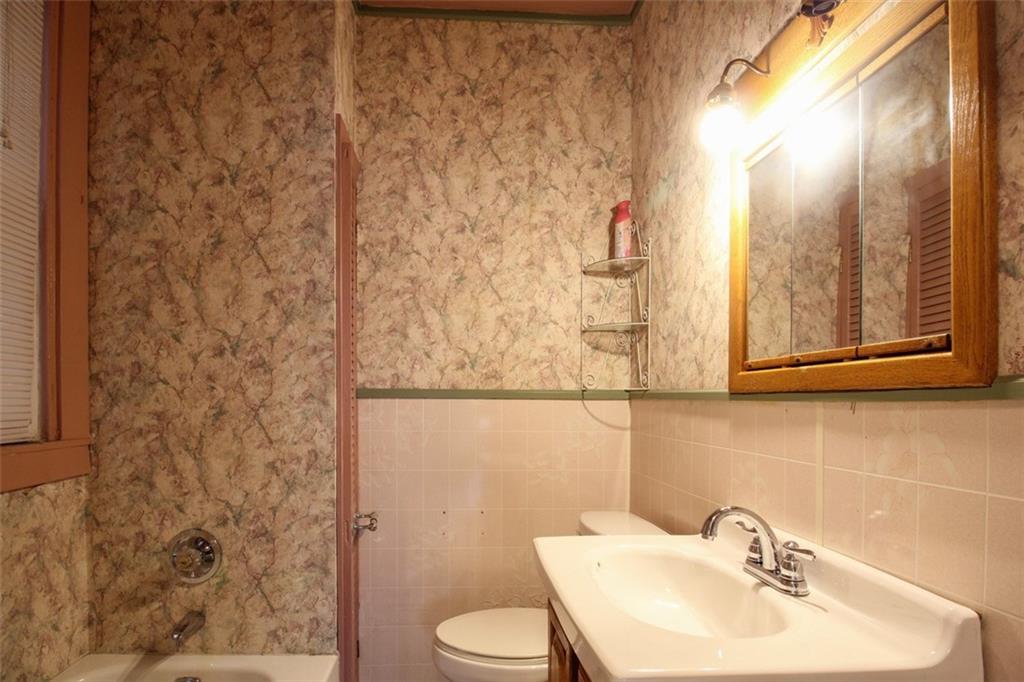 202 Jane Street McKees Rocks, PA 15136 - Photo 24 of 44 a bathroom with a sink a toilet and shower curtain