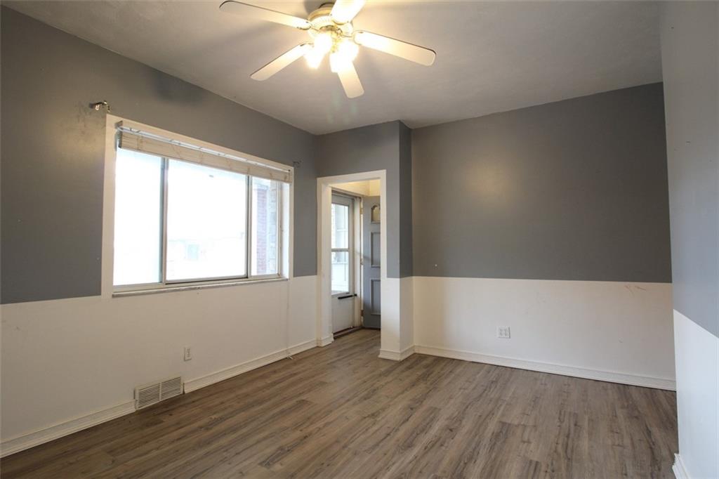 202 Jane Street McKees Rocks, PA 15136 - Photo 8 of 44 an empty room with wooden floor and windows
