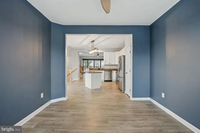 a view of a kitchen with wooden floor