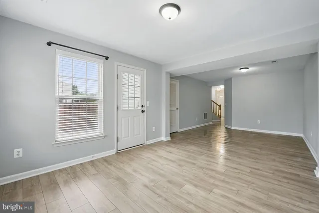wooden floor in an empty room with a window