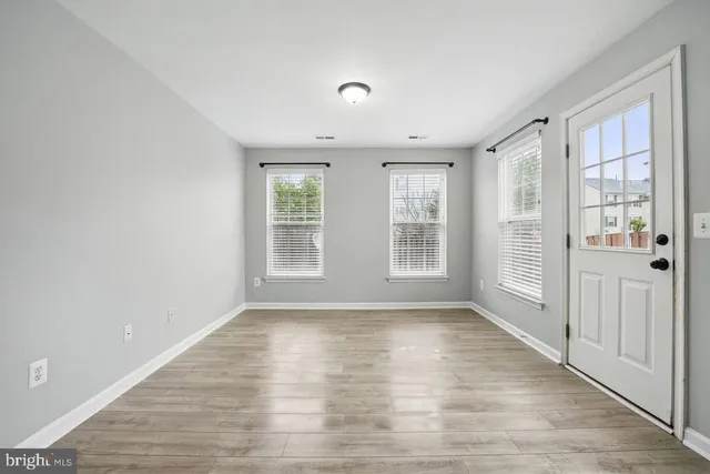 wooden floor in an empty room with a window