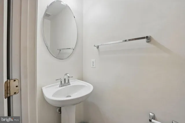 a bathroom with a sink a shower curtain and a mirror