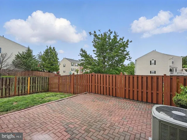 a view of backyard with wooden fence