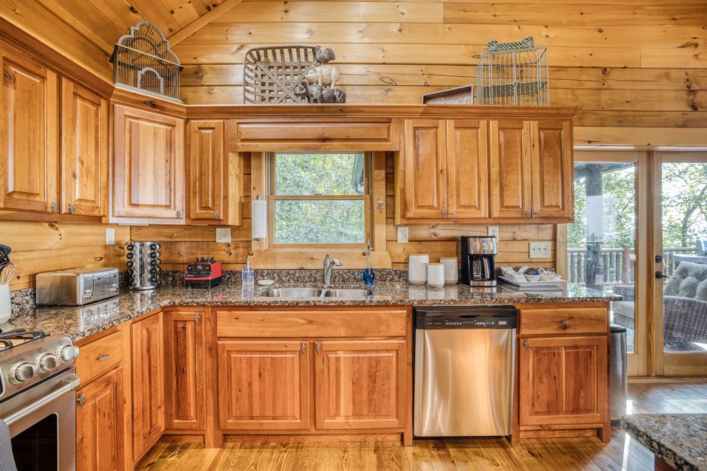 1447 Grandeur Drive Blue Ridge, GA 30513 - Photo 13 of 60 a kitchen with stainless steel appliances granite countertop a sink a stove and cabinets