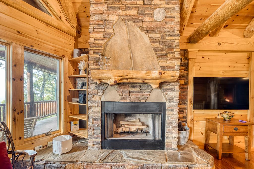 1447 Grandeur Drive Blue Ridge, GA 30513 - Photo 17 of 60 a fireplace with a clock on top of it