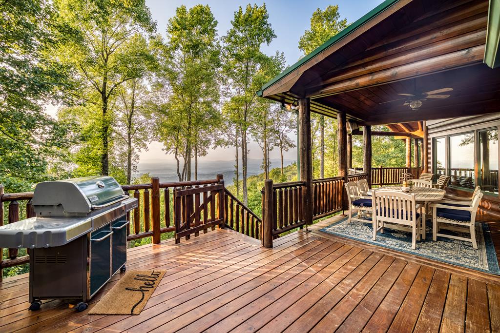 1447 Grandeur Drive Blue Ridge, GA 30513 - Photo 19 of 60 a view of a deck with table and chairs and wooden floor