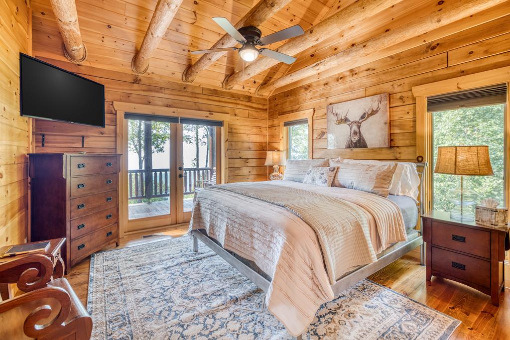 1447 Grandeur Drive Blue Ridge, GA 30513 - Photo 20 of 60 a bedroom with a bed and wooden floor