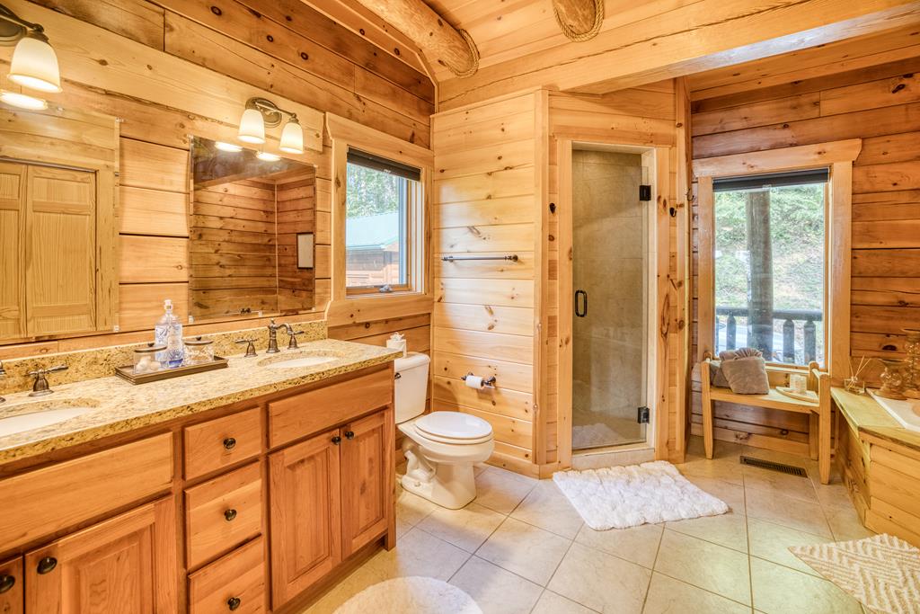 1447 Grandeur Drive Blue Ridge, GA 30513 - Photo 22 of 60 a spacious bathroom with a double vanity sink toilet and shower
