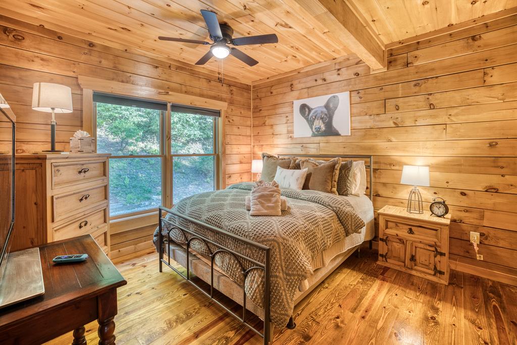 1447 Grandeur Drive Blue Ridge, GA 30513 - Photo 26 of 60 a bedroom with a bed and a flat tv screen on the dresser