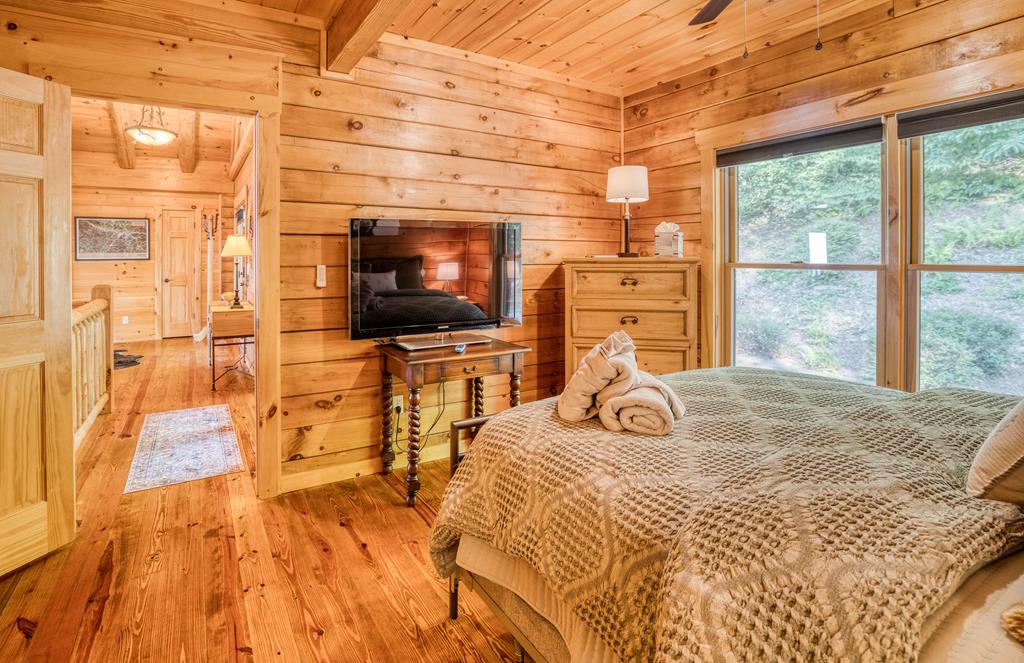 1447 Grandeur Drive Blue Ridge, GA 30513 - Photo 27 of 60 a bedroom with a bed and flat screen tv