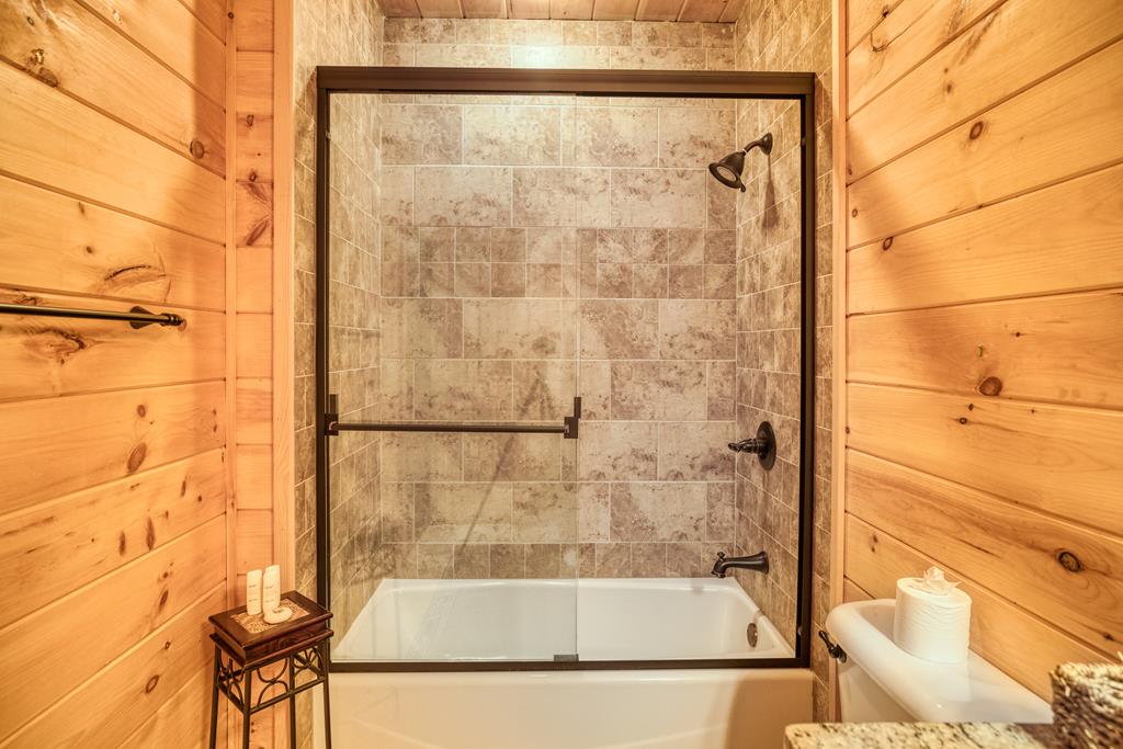 1447 Grandeur Drive Blue Ridge, GA 30513 - Photo 30 of 60 a bathroom with a bathtub and shower