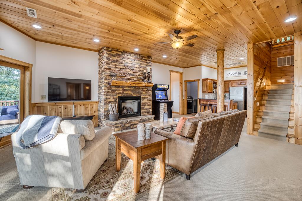 1447 Grandeur Drive Blue Ridge, GA 30513 - Photo 32 of 60 a living room with fireplace furniture and a flat screen tv