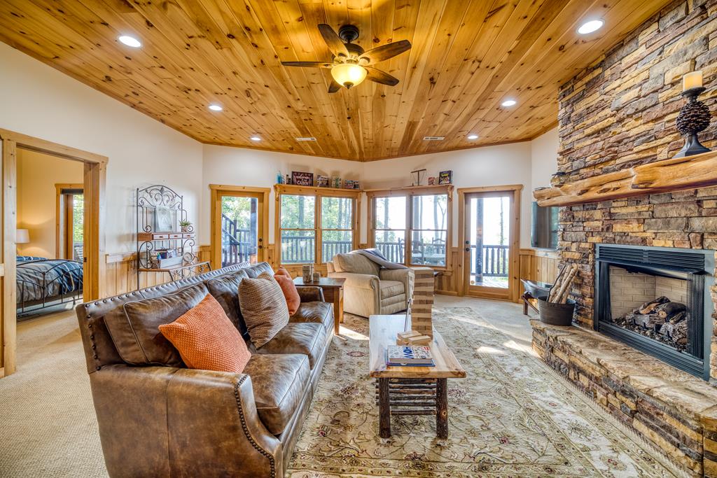 1447 Grandeur Drive Blue Ridge, GA 30513 - Photo 35 of 60 a living room with furniture a fireplace and a dining table