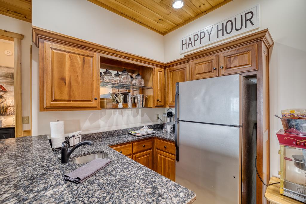 1447 Grandeur Drive Blue Ridge, GA 30513 - Photo 36 of 60 a kitchen with a refrigerator a sink and cabinets