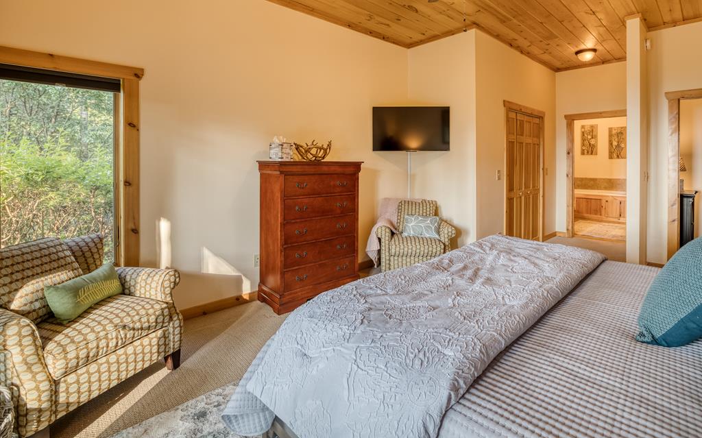 1447 Grandeur Drive Blue Ridge, GA 30513 - Photo 41 of 60 a bedroom with a bed and wooden floor