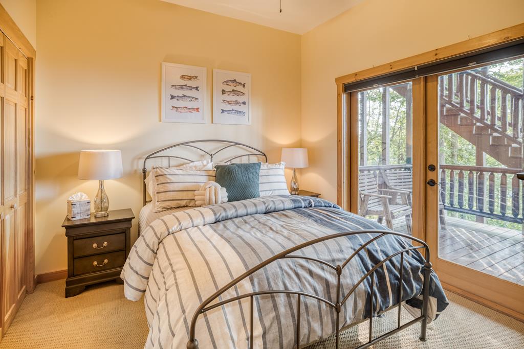 1447 Grandeur Drive Blue Ridge, GA 30513 - Photo 44 of 60 a bedroom with a bed and two windows