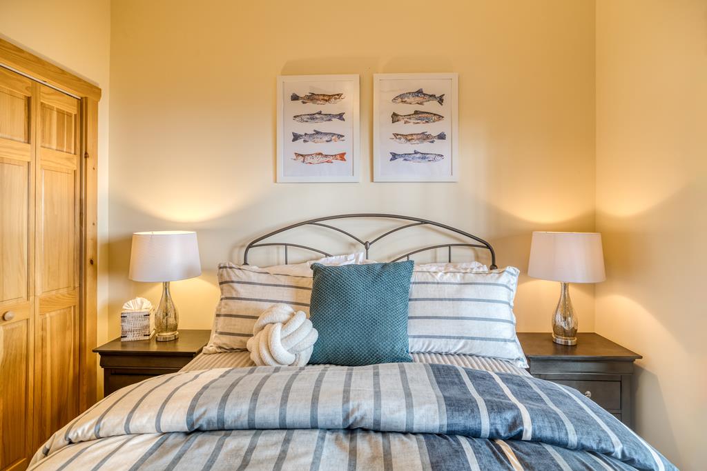 1447 Grandeur Drive Blue Ridge, GA 30513 - Photo 45 of 60 a bedroom with a bed and a night stand