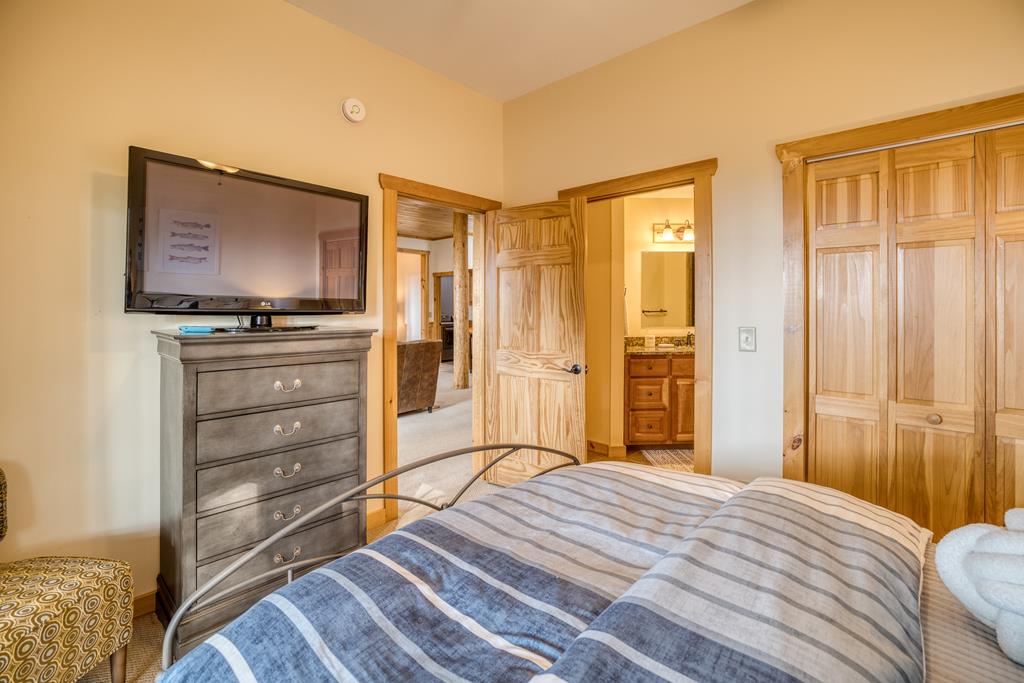 1447 Grandeur Drive Blue Ridge, GA 30513 - Photo 46 of 60 a bedroom with a bed and a flat screen tv