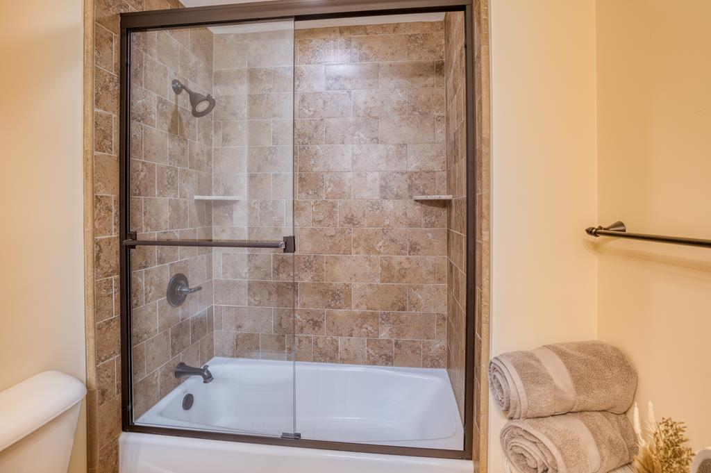 1447 Grandeur Drive Blue Ridge, GA 30513 - Photo 48 of 60 a bathroom with a glass shower door