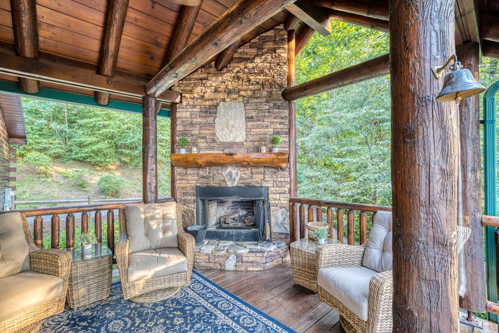 1447 Grandeur Drive Blue Ridge, GA 30513 - Photo 53 of 60 a living room with furniture a fireplace and a floor to ceiling window
