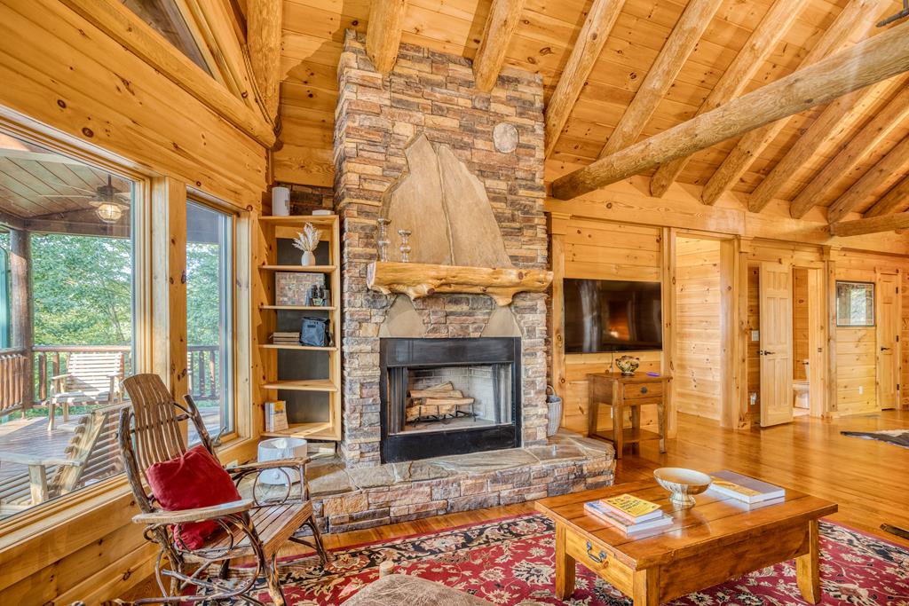 1447 Grandeur Drive Blue Ridge, GA 30513 - Photo 10 of 60 a living room with furniture a fireplace and a flat screen tv