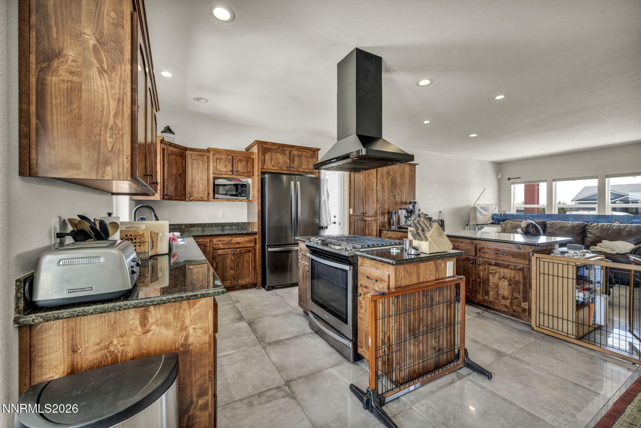 1286 Sky Ridge Drive Fallon, NV 89406 - Photo 7 of 49 a kitchen with stainless steel appliances granite countertop a stove sink and cabinets