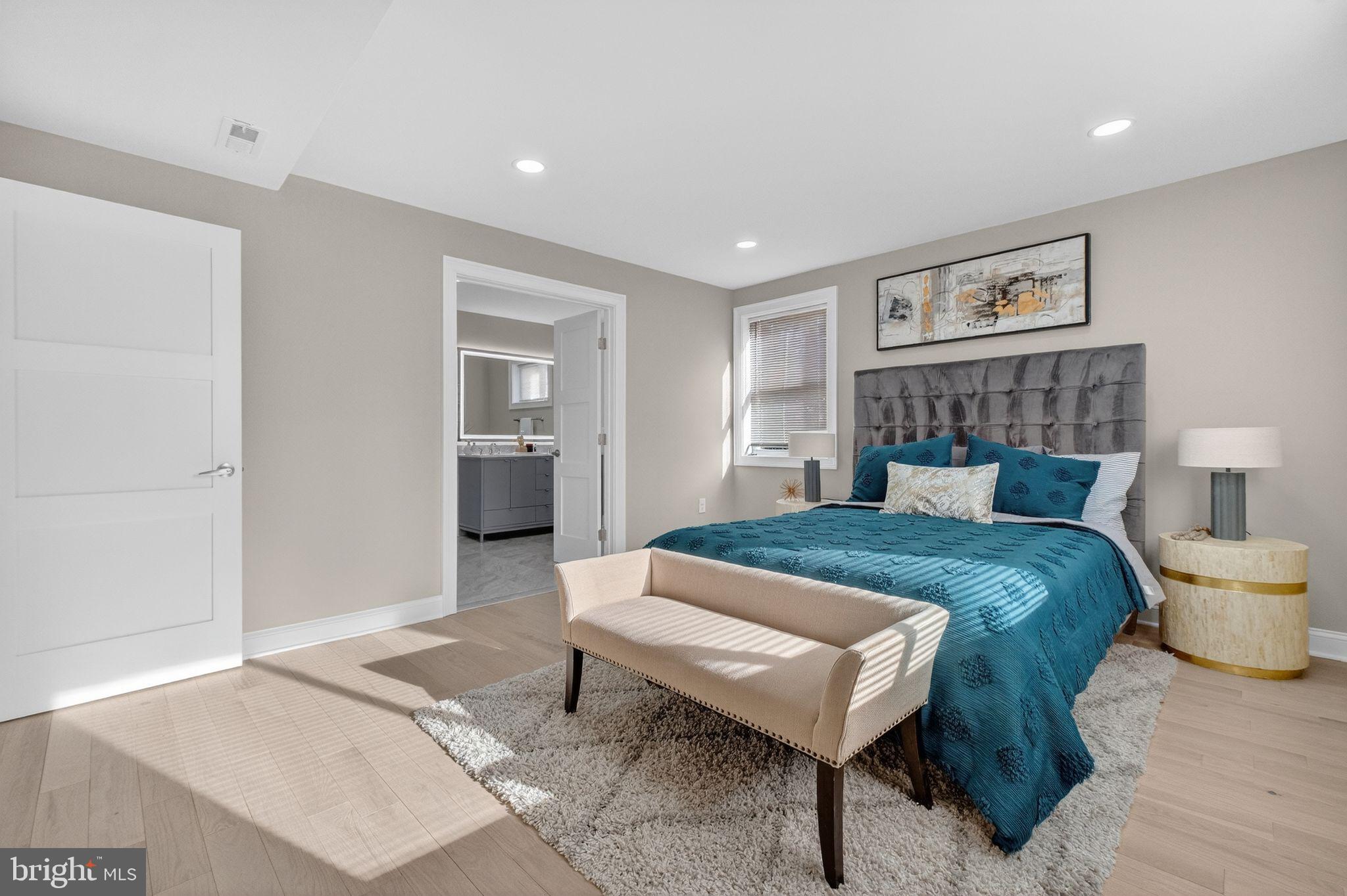 3151 Newton Street Northeast Washington, DC 20018 - Photo 14 of 49 a spacious bedroom with a bed and a table in it