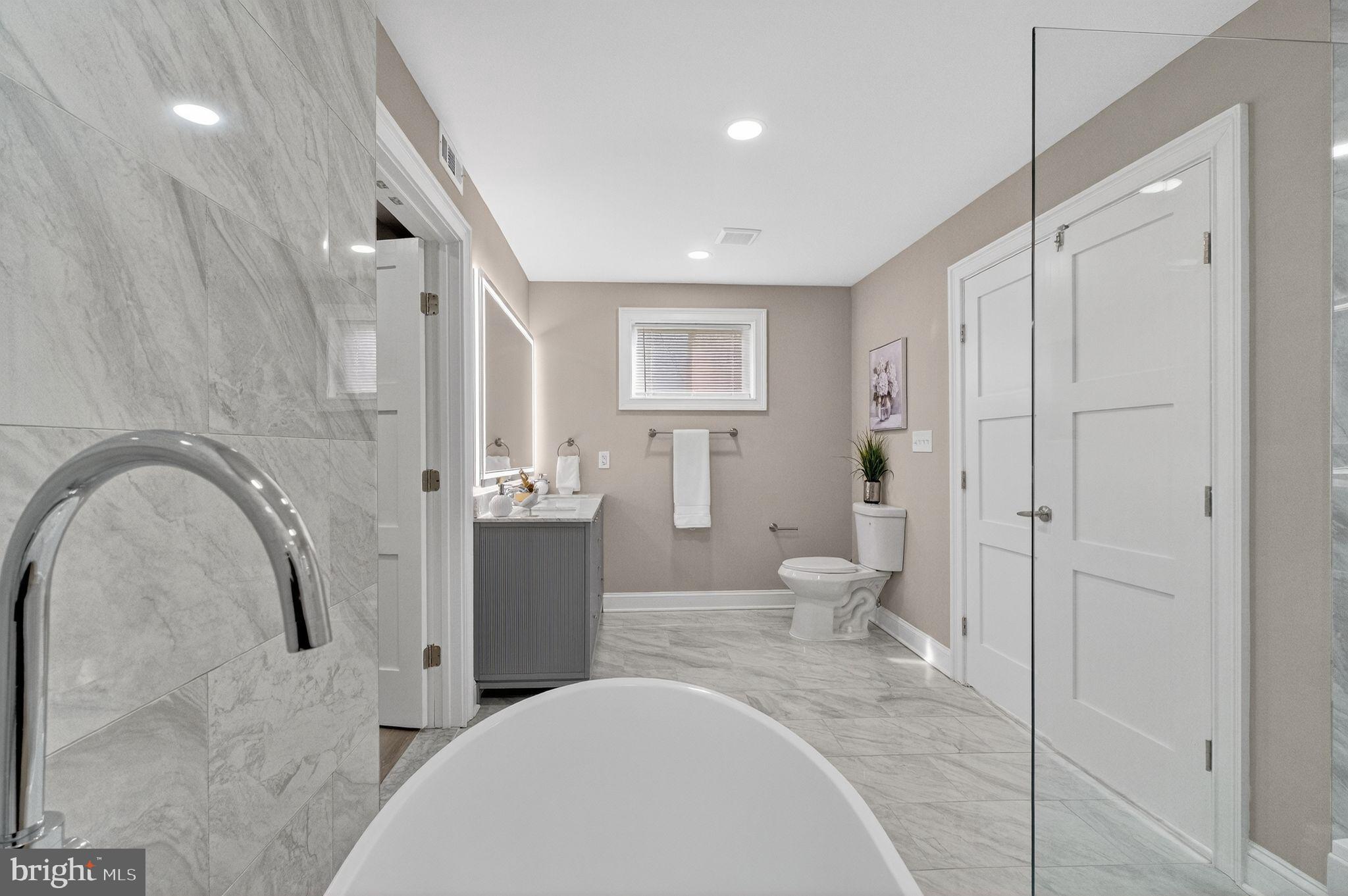 3151 Newton Street Northeast Washington, DC 20018 - Photo 15 of 49 a bathroom with a sink a toilet and shower