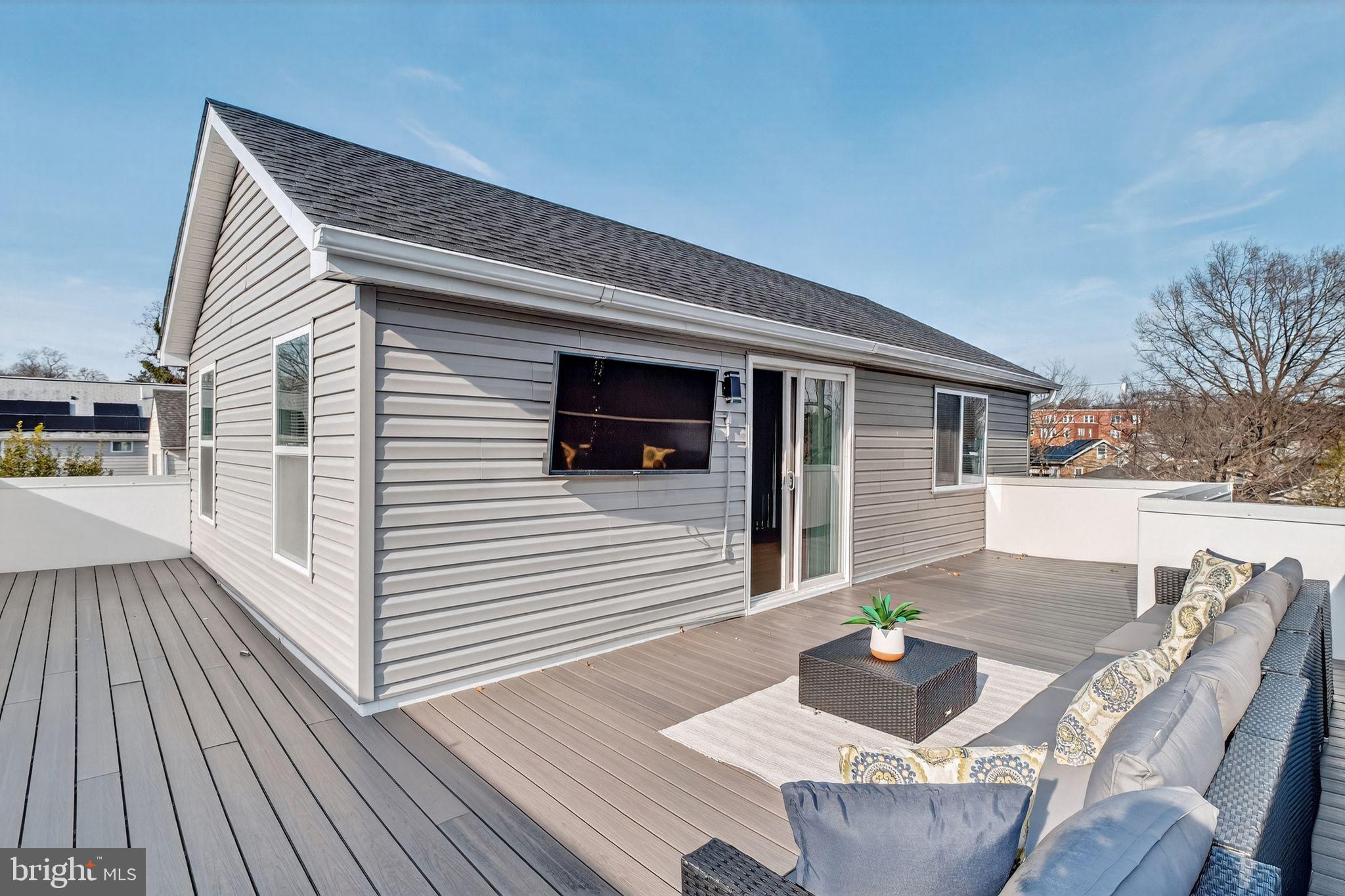 3151 Newton Street Northeast Washington, DC 20018 - Photo 29 of 49 a view of a patio with couches table and chairs with wooden floor