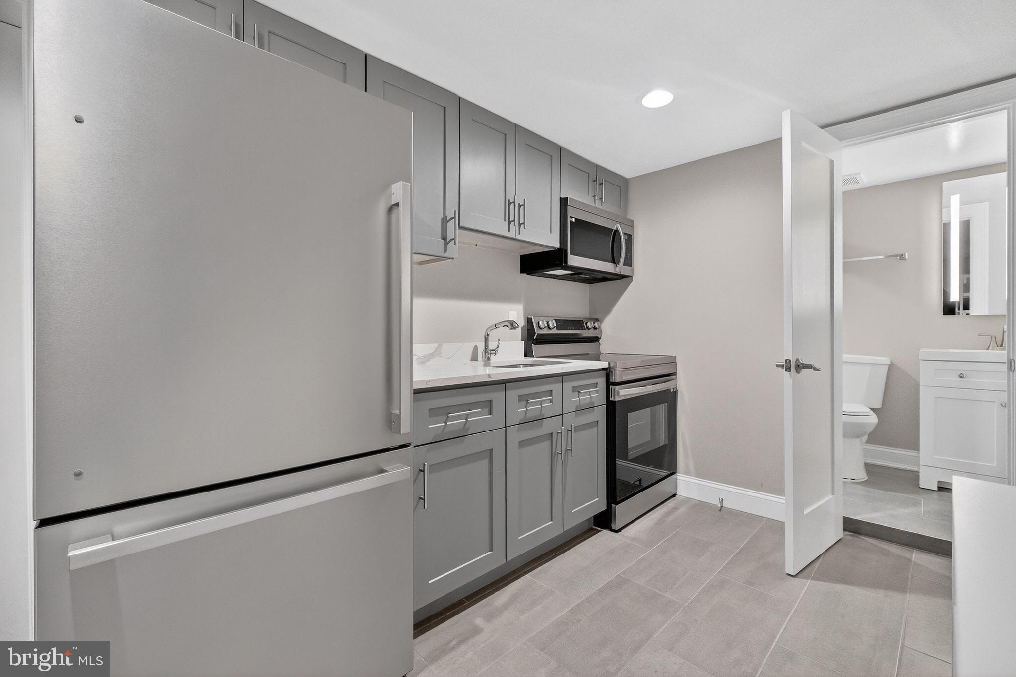 3151 Newton Street Northeast Washington, DC 20018 - Photo 36 of 49 a kitchen with stainless steel appliances a refrigerator stove and sink