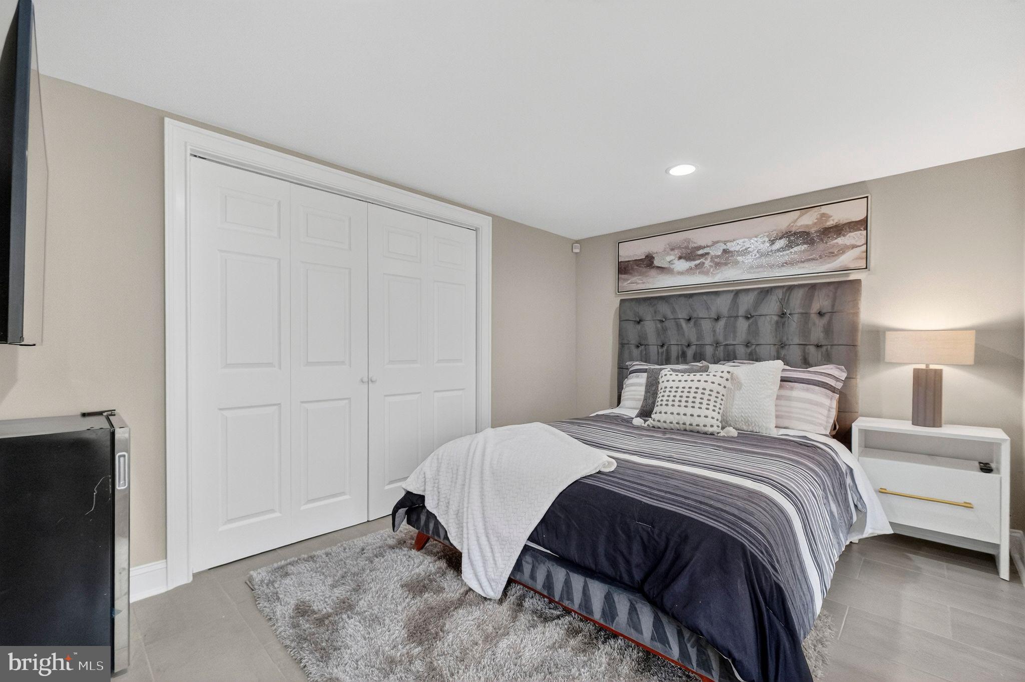 3151 Newton Street Northeast Washington, DC 20018 - Photo 41 of 49 a bedroom with a bed and a night stand