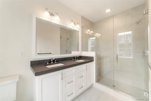 a bathroom with double sink and a mirror