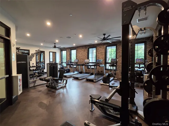 a view of a big house with a big yard and potted plants