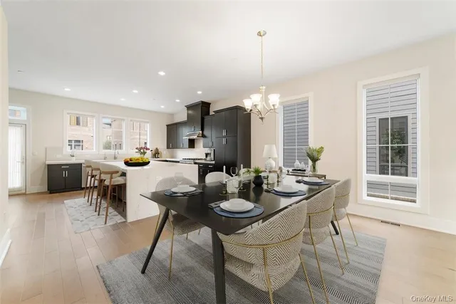 a kitchen with stainless steel appliances kitchen island granite countertop a table and chairs